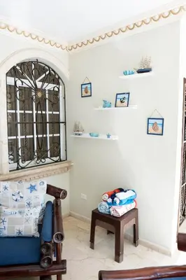 a living room with a blue couch and a table at Villa La Dueña - Vista Hermosa Luxury Retreat, 5BR Villa with Pool, Swim-Up Bar, Jacuzzi, Chef's Kitchen, Fast Wi-Fi, Full AC, EV Charger and Solar Power, Ideal for Families & Groups in Cancino