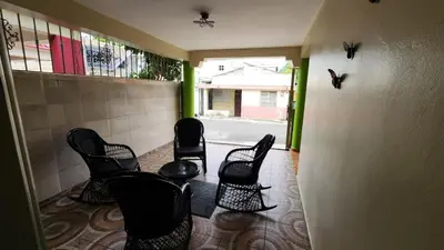 a group of chairs sitting in a hallway at Airbnbbuenhogar in Concepción de La Vega