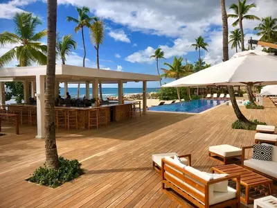 a wooden deck with a bar and the beach at Villa en Casa de Campo 10127 in Colorado