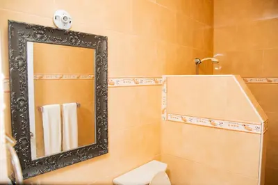 a bathroom with a mirror and a toilet at Boom Ranch in Las Galeras