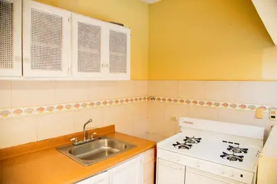 a kitchen with a white stove and a sink at Boom Ranch in Las Galeras