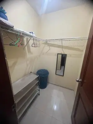 a room with a closet with a shelf and a staircase at Tú hogar en ciudad Juan Bosch in Los Paredones