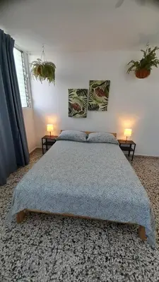 a bedroom with a bed and two lamps on two tables at Apartment in the heart of the DISTRITO NACIONAL in Santo Domingo