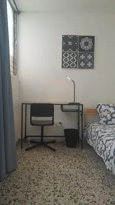 a bedroom with a desk with a chair and a bed at Apartment in the heart of the DISTRITO NACIONAL in Santo Domingo