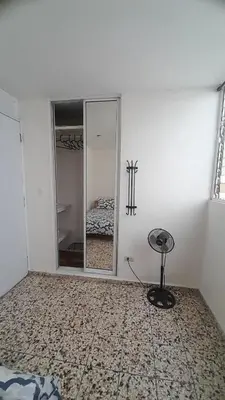 a room with a mirror and a stool in it at Apartment in the heart of the DISTRITO NACIONAL in Santo Domingo