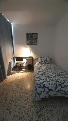 a bedroom with a bed and a desk and a chair at Apartment in the heart of the DISTRITO NACIONAL in Santo Domingo