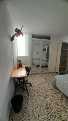 a room with a desk and a bed and a mirror at Apartment in the heart of the DISTRITO NACIONAL in Santo Domingo
