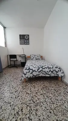 a bedroom with a bed and a desk at Apartment in the heart of the DISTRITO NACIONAL in Santo Domingo