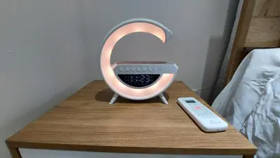 a alarm clock on a table next to a remote control at Modern and Luxury apartment in La Grúa