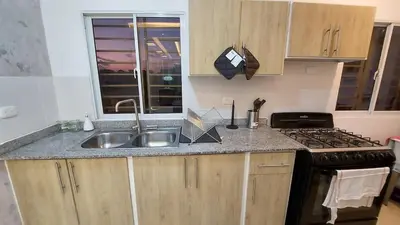 a kitchen with a sink and a stove at Modern and Luxury apartment in La Grúa