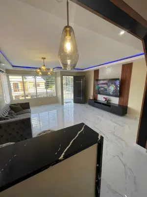 a large living room with a couch and a tv at Apartamento 2 in Cancino