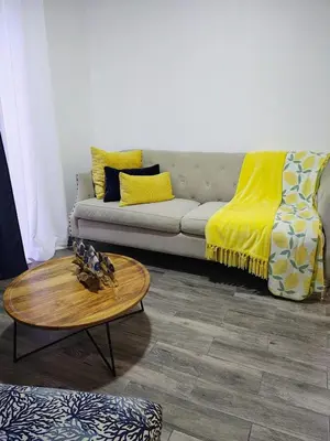 a living room with a couch and a coffee table at Sunflower Bayahibe with pool in Bayahibe