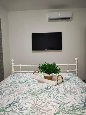 a bedroom with a bed with a potted plant on it at Sunflower Bayahibe with pool in Bayahibe