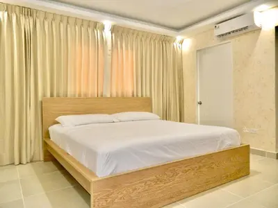 a bedroom with a large bed with white sheets at The Chic Hideout full apt in san isidro Terrace in Juan López