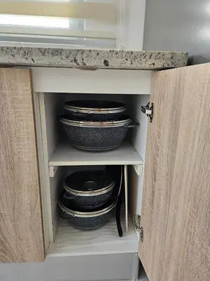a cupboard with plates and bowls in it at Paradise Escape Villa 201 2br Private Pool in Punta Cana