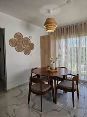 a dining room with a wooden table and chairs at Paradise Escape Villa 201 2br Private Pool in Punta Cana
