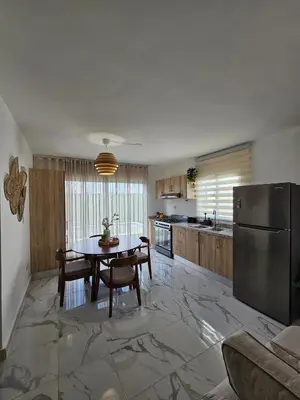 a large kitchen with a table and a refrigerator at Paradise Escape Villa 201 2br Private Pool in Punta Cana