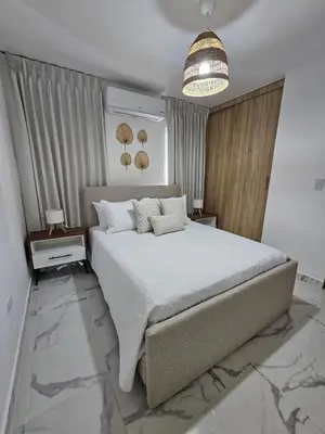 a bedroom with a large bed and a chandelier at Paradise Escape Villa 201 2br Private Pool in Punta Cana