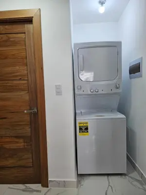 a small television sitting on top of a refrigerator at Paradise Escape Villa 201 2br Private Pool in Punta Cana