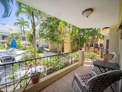 a balcony with chairs and a view of a street at Garden Condos 7 - Central Apartment in Strip in Sosúa