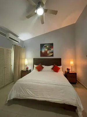 a bedroom with a bed with a ceiling fan at La Mansion en SAJOMA Villa 15 3br with private Pool in San José de Las Matas