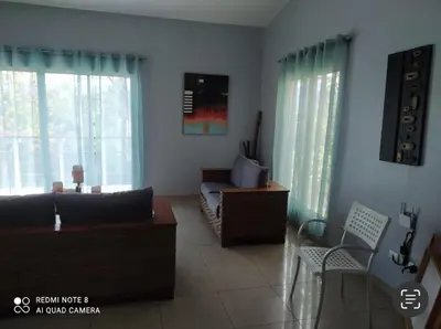 a living room with a couch and a chair at La Mansion en SAJOMA Villa 15 3br with private Pool in San José de Las Matas
