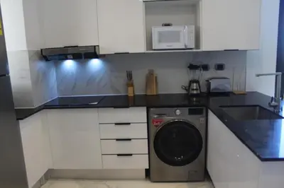 a kitchen with a washing machine and a sink at Blue Paradise Punta Cana in Punta Cana