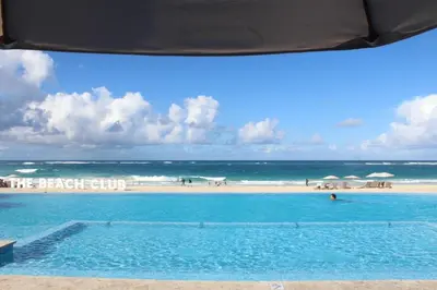 a swimming pool with a beach in the background at Blue Paradise Punta Cana in Punta Cana