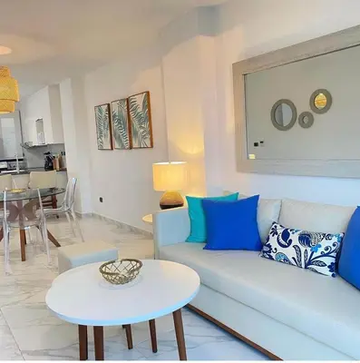 a living room with a couch and a table at Blue Paradise Punta Cana in Punta Cana