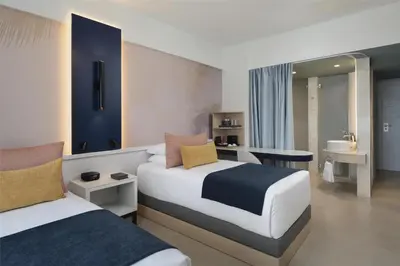a hotel room with two beds and a bathroom at Royal Beach Hotel Punta Cana, A JdV by Hyatt in Punta Cana