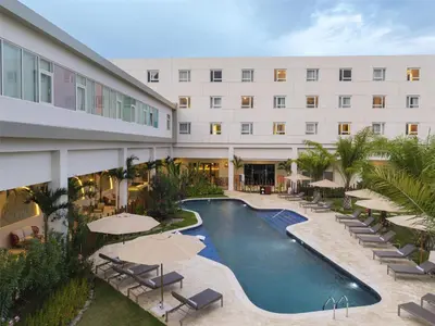 a hotel with a swimming pool with umbrellas and chairs at Royal Beach Hotel Punta Cana, A JdV by Hyatt in Punta Cana