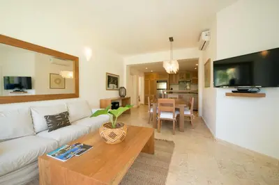 a living room with a white couch and a table at Coson Bay in Las Terrenas