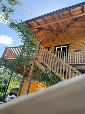 a wooden house with a wooden staircase leading up to it at Villas Gabriel in Nagua