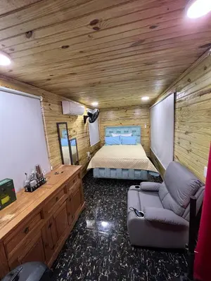 a bedroom with a bed and a couch in a room at Villas Gabriel in Nagua