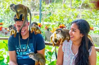 a man and a woman with monkeys on their heads at Villas Las Indigenas in Imbert