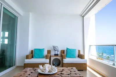 a living room with a table and chairs and a window at Condominio Marbella Juan Dolio in Villas del Mar