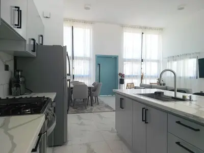 a kitchen with a sink and a stove top oven at Modern 3 BR Villa with pool in gated community in Sosúa