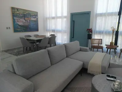 a living room with a couch and a table at Modern 3 BR Villa with pool in gated community in Sosúa
