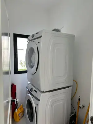 a washer and dryer stacked on top of each other at Modern 3 BR Villa with pool in gated community in Sosúa