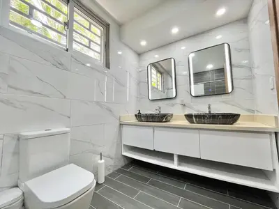 a bathroom with two sinks and two mirrors at magnifica villa en cabrera in Cabrera