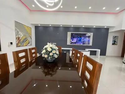 a dining room with a table with a vase of flowers at magnifica villa en cabrera in Cabrera
