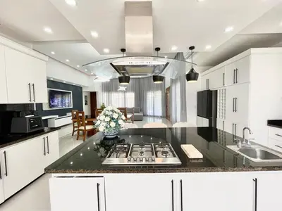 a kitchen with white cabinets and a counter top at magnifica villa en cabrera in Cabrera