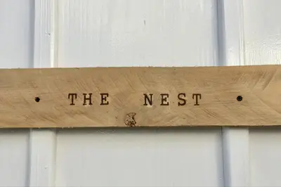 a wooden sign that reads the nest on a window at JAVO BEACH the Nest in Las Galeras