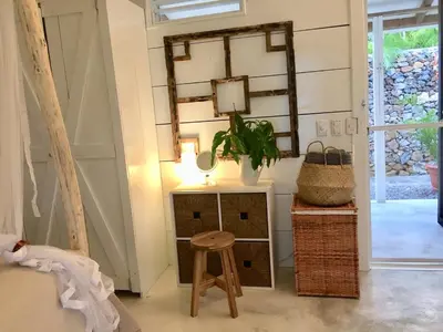 a stool in a room with a mirror and a table at JAVO BEACH the Nest in Las Galeras