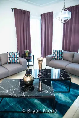 a living room with two couches and a table at Eclectic gorgeous, modern 3 levels penthouse in Santo Domingo
