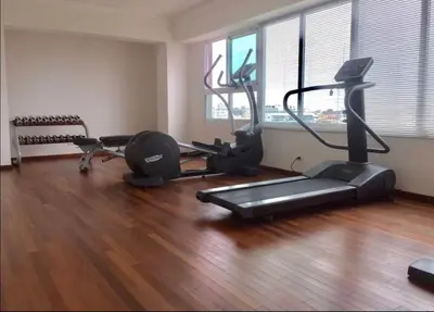 a gym with a treadmill and some exercise bikes at Eclectic gorgeous, modern 3 levels penthouse in Santo Domingo
