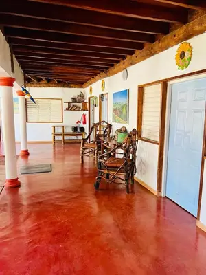 a living room with a table and chairs in it at The Coco Garden Cabin in Las Galeras