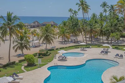 an aerial view of a resort with a swimming pool at Escape Beachfront Condo Costa del Sol Juan Dolio in Los Corrales