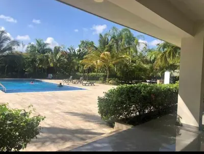 a swimming pool with palm trees in a resort at Apartamento Tipo resort-style space in Santiago de los Caballeros