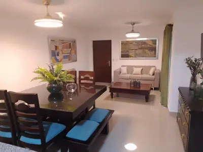 a living room with a table and chairs and a couch at Apartamento Tipo resort-style space in Santiago de los Caballeros